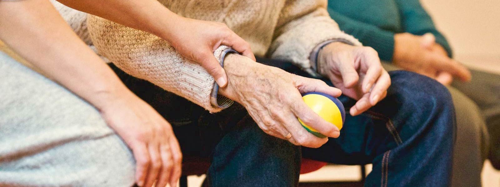 Younger hand holding elderly hand.